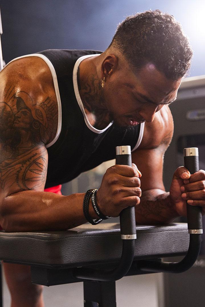 Man performing a leg exercise on a weight machine at the gym