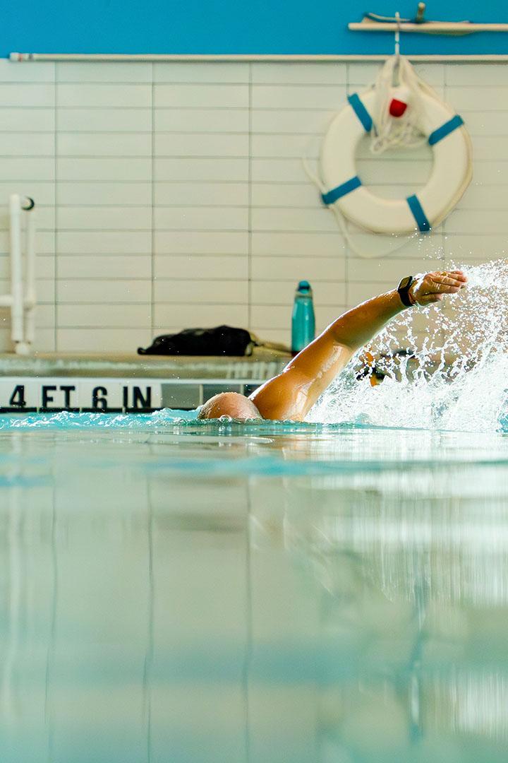 Person swimming in an indoor pool