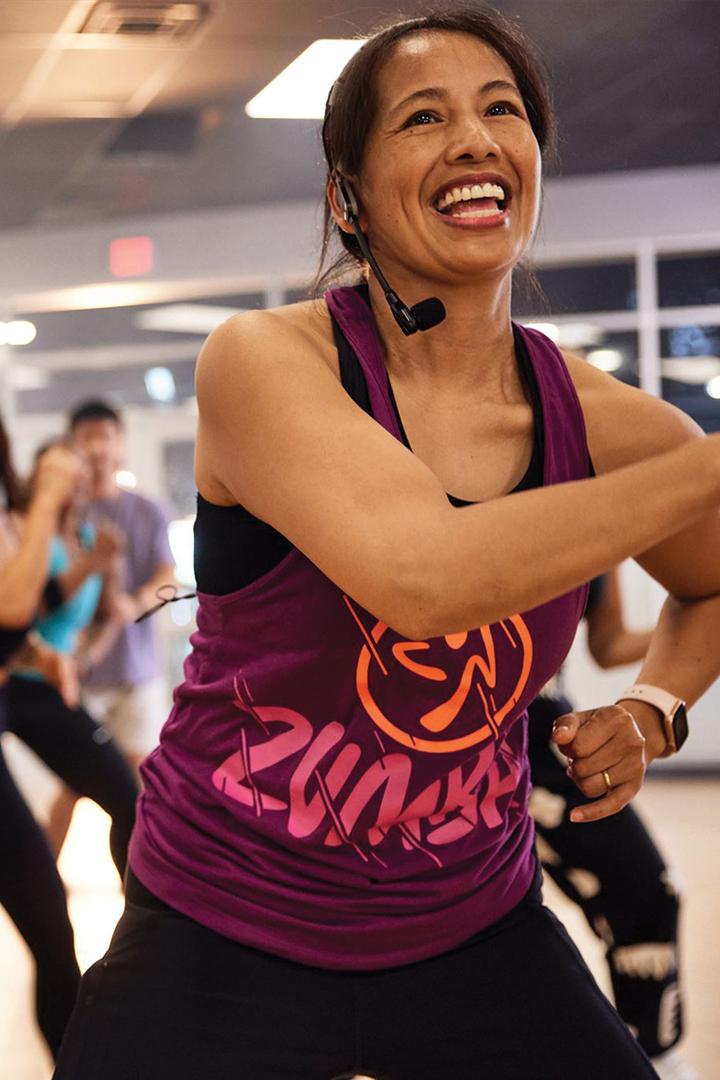 zumba instructor leading a group dance class