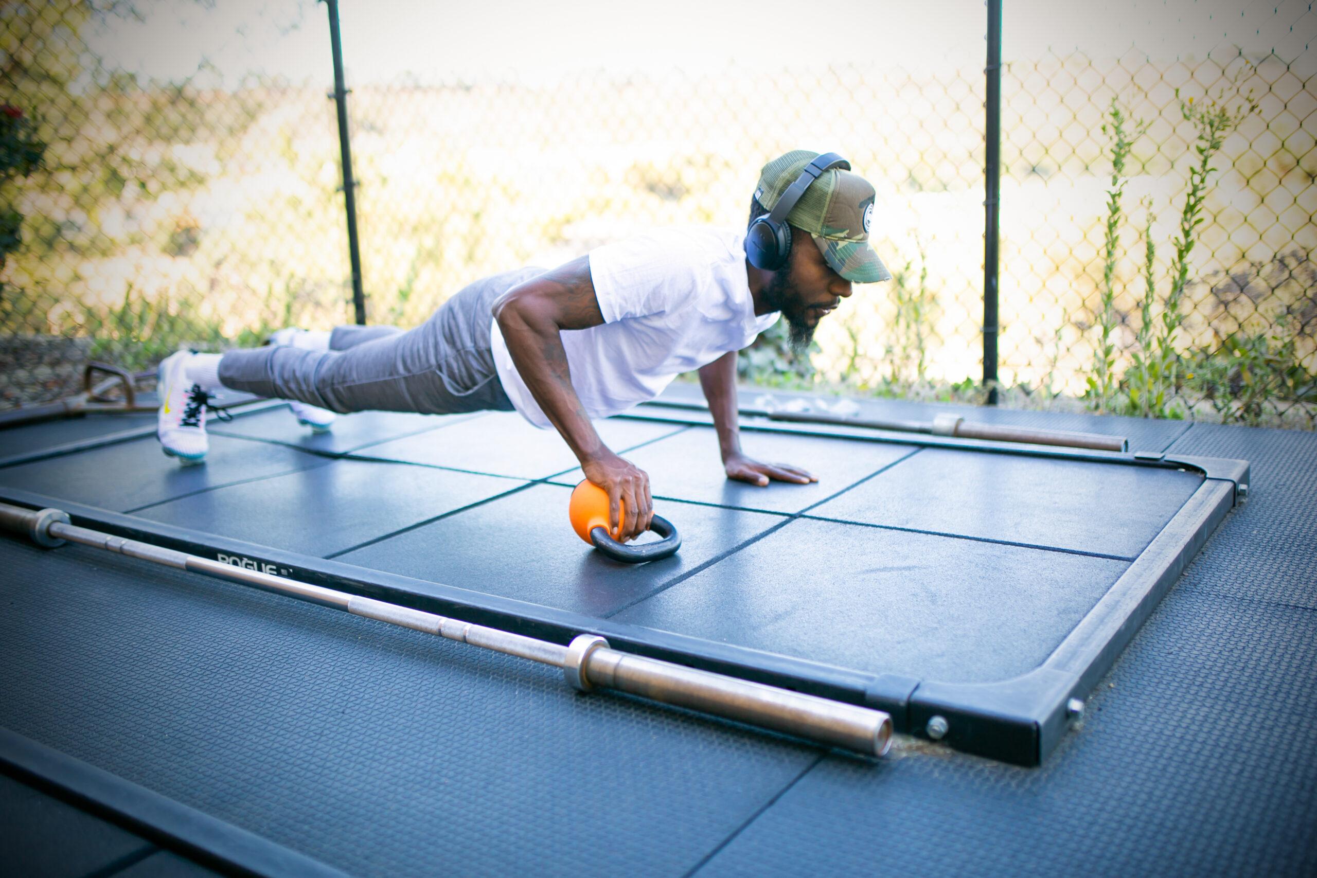 eos gym member doing push up variations outside