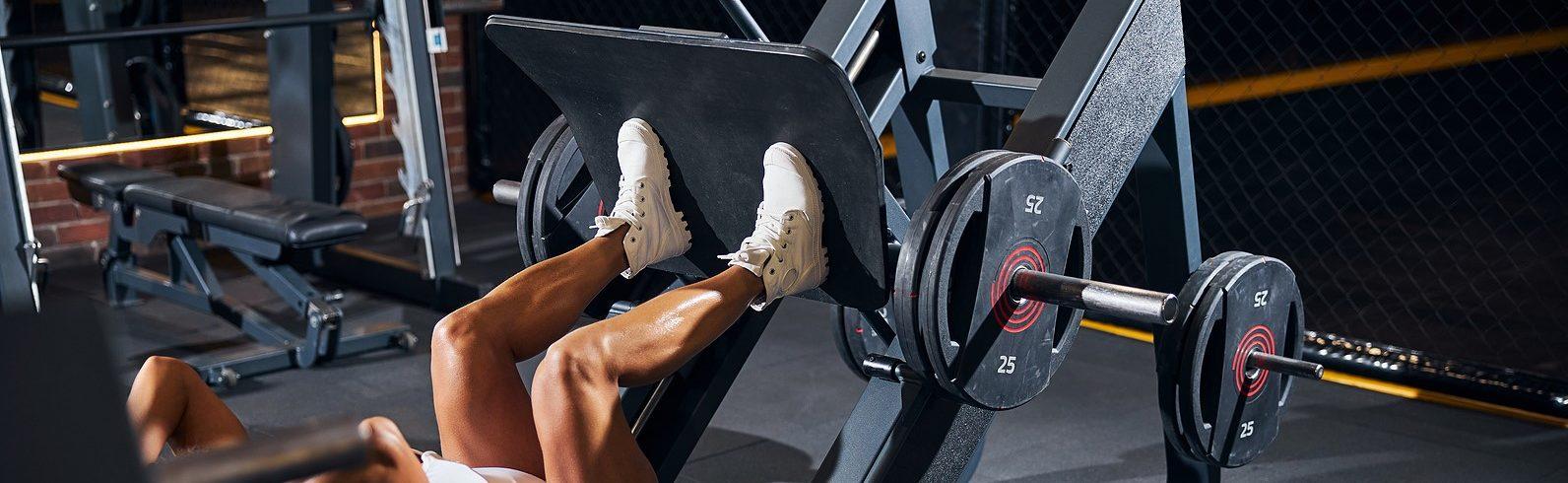 women using leg press machine for workout