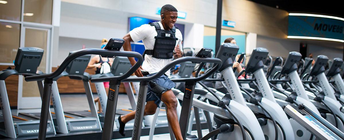 athletic eos gym member race training on a treadmill