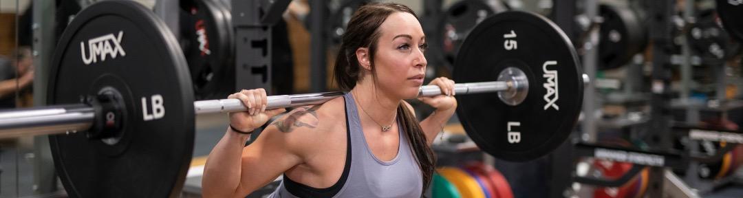 athletic eos gym member doing barbell squats