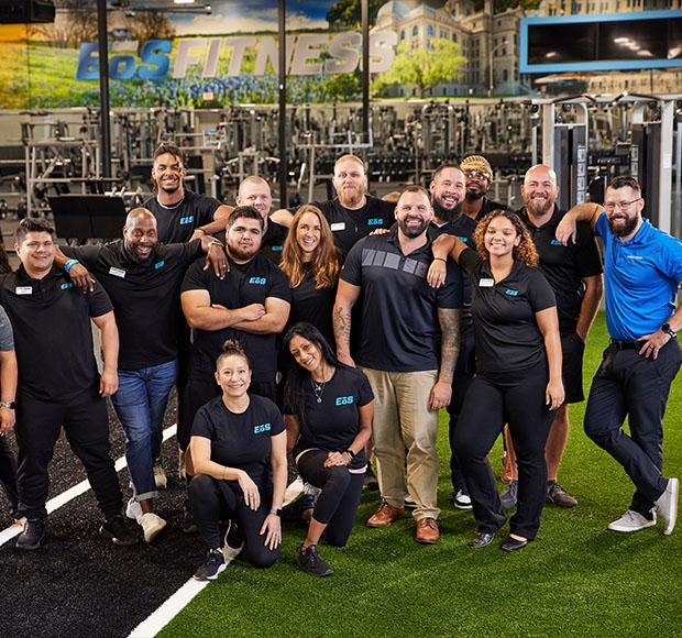 a group photo of several different members of eos staff standing and smiling 