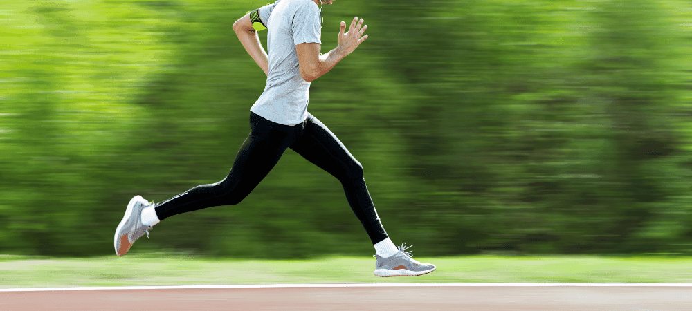 an athletic person sprinting down an outdoor track